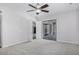 Large bedroom with a neutral carpet, ceiling fan, closet and sliding glass door at 1394 E Grand Canyon Dr, Chandler, AZ 85249