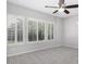 Neutral bedroom with bright white shuttered windows and a ceiling fan at 1394 E Grand Canyon Dr, Chandler, AZ 85249