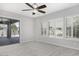 Neutral bedroom with access to private patio, plush carpeting, and bright white window shutters at 1394 E Grand Canyon Dr, Chandler, AZ 85249