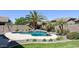 Backyard pool surrounded by lush landscaping and desert flora at 1394 E Grand Canyon Dr, Chandler, AZ 85249