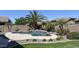 Backyard pool area featuring lush tropical landscaping and a stone waterfall feature at 1394 E Grand Canyon Dr, Chandler, AZ 85249