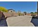 Large backyard featuring desert landscaping and a privacy wall at 14214 W Ventura St, Surprise, AZ 85379