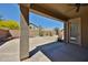 Backyard with a covered patio, desert landscaping, and privacy wall at 14214 W Ventura St, Surprise, AZ 85379