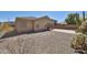 Back exterior of home featuring a covered patio and desert landscaping at 14214 W Ventura St, Surprise, AZ 85379
