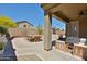 Spacious backyard with a covered patio, dining area, and desert landscaping, perfect for outdoor enjoyment at 14214 W Ventura St, Surprise, AZ 85379