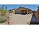 Back exterior of home with desert landscaping at 14214 W Ventura St, Surprise, AZ 85379