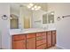 Bathroom with double sink vanity and a large mirror at 14214 W Ventura St, Surprise, AZ 85379