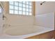 Close up of soaking tub with glass block window for natural light at 14214 W Ventura St, Surprise, AZ 85379