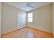Bedroom with light walls, wood floors, ceiling fan and closet at 14214 W Ventura St, Surprise, AZ 85379