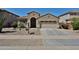 Charming single-story home with a desert-landscaped front yard and two car garage at 14214 W Ventura St, Surprise, AZ 85379