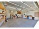Spacious garage with workbench, storage, and shelving at 14214 W Ventura St, Surprise, AZ 85379