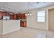 Modern kitchen and dining area with tile flooring and stainless steel appliances at 14214 W Ventura St, Surprise, AZ 85379