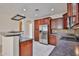 A modern kitchen with stainless steel appliances and dark wood cabinetry at 14214 W Ventura St, Surprise, AZ 85379