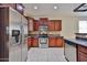 Well-equipped kitchen with stainless steel appliances and dark wood cabinetry at 14214 W Ventura St, Surprise, AZ 85379