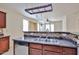 Open kitchen featuring stainless steel dishwasher, double sinks, tile backsplash and overhead pot rack at 14214 W Ventura St, Surprise, AZ 85379