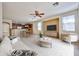 Open-concept living room boasts hardwood floors, a ceiling fan, and is open to the adjacent dining area at 14214 W Ventura St, Surprise, AZ 85379
