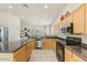 Well-lit kitchen with stainless steel appliances, plenty of counter space, and wood cabinetry at 15201 N Zapata Dr, Fountain Hills, AZ 85268