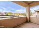 View of a neutral-toned balcony overlooking residential buildings and carports at 16013 S Desert Foothills Pkwy # 2055, Phoenix, AZ 85048