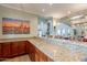 Stylish bar area with granite countertops, wooden cabinets, and seating for casual entertaining at 16013 S Desert Foothills Pkwy # 2055, Phoenix, AZ 85048