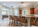 Stylish bar area with granite countertops, wooden cabinets, and seating for casual entertaining at 16013 S Desert Foothills Pkwy # 2055, Phoenix, AZ 85048