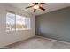 This carpeted bedroom offers a ceiling fan and bright natural light at 16013 S Desert Foothills Pkwy # 2055, Phoenix, AZ 85048