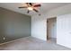 The carpeted bedroom features a ceiling fan and adjoins another room at 16013 S Desert Foothills Pkwy # 2055, Phoenix, AZ 85048