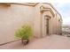 Inviting condo entryway featuring a large potted plant and welcome mat at 16013 S Desert Foothills Pkwy # 2055, Phoenix, AZ 85048