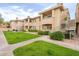 Charming condo featuring lush green lawns, desert landscaping, and private balconies at 16013 S Desert Foothills Pkwy # 2055, Phoenix, AZ 85048