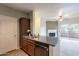 Open-concept kitchen with stainless steel appliances, a breakfast bar, and views of the living area and outdoor balcony at 16013 S Desert Foothills Pkwy # 2055, Phoenix, AZ 85048