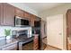 Cozy kitchen features stainless steel appliances and dark wood cabinetry, providing ample storage and cooking space at 16013 S Desert Foothills Pkwy # 2055, Phoenix, AZ 85048