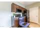 Charming kitchen featuring stainless steel appliances and dark wood cabinets, complemented by a stylish countertop at 16013 S Desert Foothills Pkwy # 2055, Phoenix, AZ 85048