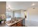 Bright kitchen featuring a stainless steel dishwasher and a double sink overlooking the spacious living area and balcony at 16013 S Desert Foothills Pkwy # 2055, Phoenix, AZ 85048