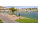 Scenic lakeside walking path with lush landscaping and a fountain, perfect for leisurely strolls at 16013 S Desert Foothills Pkwy # 2055, Phoenix, AZ 85048