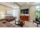 Cozy living room featuring comfortable leather couches, a large TV, and warm lighting for relaxation at 16013 S Desert Foothills Pkwy # 2055, Phoenix, AZ 85048