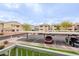 View of the parking area, adjacent community buildings, and lush desert landscaping at 16013 S Desert Foothills Pkwy # 2055, Phoenix, AZ 85048
