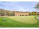 Well-maintained putting green surrounded by lush landscaping and manicured lawns at 16013 S Desert Foothills Pkwy # 2055, Phoenix, AZ 85048