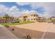 Exterior view showcasing the community sand volleyball court, grassy area, and building facade at 16013 S Desert Foothills Pkwy # 2055, Phoenix, AZ 85048