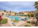 A luxurious swimming pool with lounge chairs, and a well-maintained landscape at 16013 S Desert Foothills Pkwy # 2055, Phoenix, AZ 85048