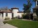 Charming single-story home showcasing unique turret feature, terracotta tile roof, and lush front lawn at 16155 N 171St Dr, Surprise, AZ 85388