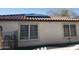 Home exterior featuring solar panels, dual-pane windows, desert landscaping, and a tiled roof at 16155 N 171St Dr, Surprise, AZ 85388