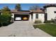 Spacious garage with two cars, solar panels on the roof, and a well-maintained driveway and landscaping at 16155 N 171St Dr, Surprise, AZ 85388