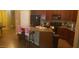 Open kitchen with granite countertops, dark wood cabinets, island with bar seating, and black appliances at 16155 N 171St Dr, Surprise, AZ 85388