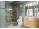 Bathroom showcasing a walk-in shower with decorative tile, a toilet, and a vanity with a mirror at 16616 E Gunsight Dr # 114, Fountain Hills, AZ 85268