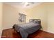 Cozy bedroom featuring hardwood floors, a queen bed, and a window with blinds at 16616 E Gunsight Dr # 114, Fountain Hills, AZ 85268