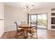 Dining room with a round wooden table, decorative chandelier, and sliding door to the outside at 16616 E Gunsight Dr # 114, Fountain Hills, AZ 85268