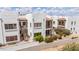Beautiful building exterior showcasing multiple balconies, lush gardens, and classic Southwestern architecture at 16616 E Gunsight Dr # 114, Fountain Hills, AZ 85268