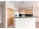 Kitchen with light wood cabinets, granite countertops, and breakfast bar at 16616 E Gunsight Dr # 114, Fountain Hills, AZ 85268