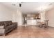Spacious living room featuring tile floors, a comfortable couch, and an open layout into the dining area at 16616 E Gunsight Dr # 114, Fountain Hills, AZ 85268