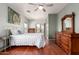 Bedroom with hardwood floors, slider to balcony, and vintage wood furniture at 16616 E Gunsight Dr # 114, Fountain Hills, AZ 85268
