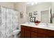 Bathroom featuring double sinks, framed mirrors, and patterned shower curtain at 16876 W Stevenage St, Surprise, AZ 85374